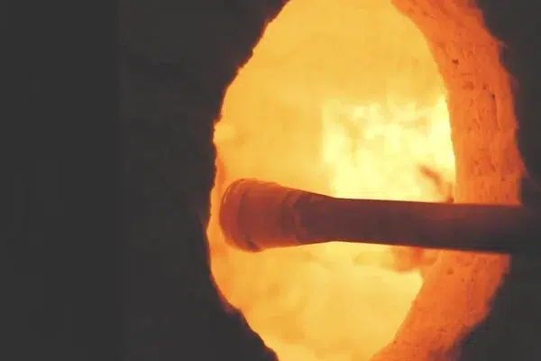 molten-glass-being-pushed-into-beautiful-yellow-furnace
